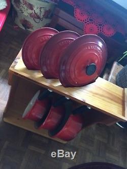 Brand new LE CREUSET CAST IRON SAUCEPANS SET CERISE RED With Wooden Stand